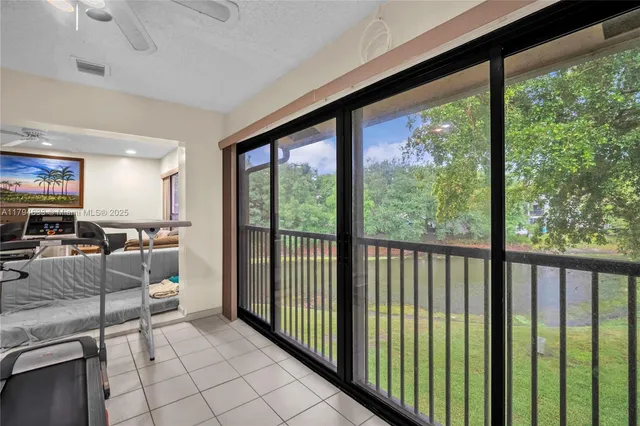 a view of a living room and balcony with furniture