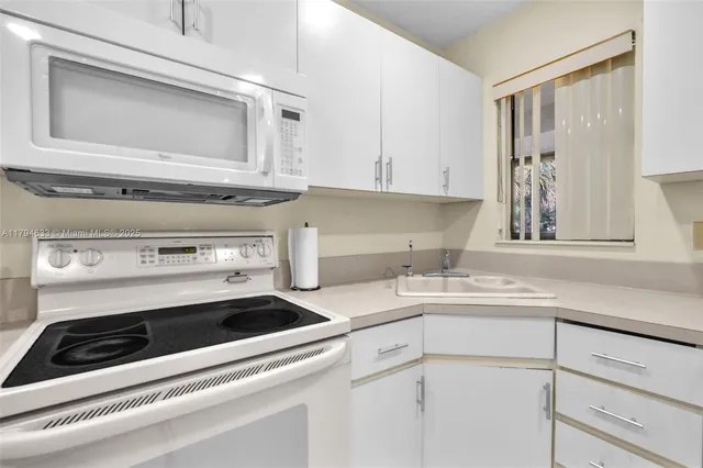 a kitchen with a stove microwave and sink