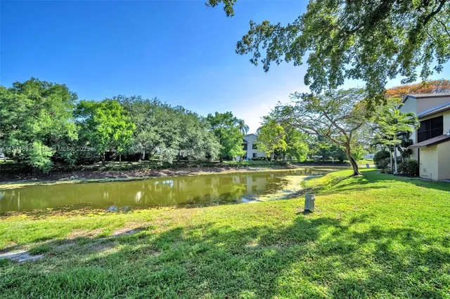 a view of a lake with a house in the background