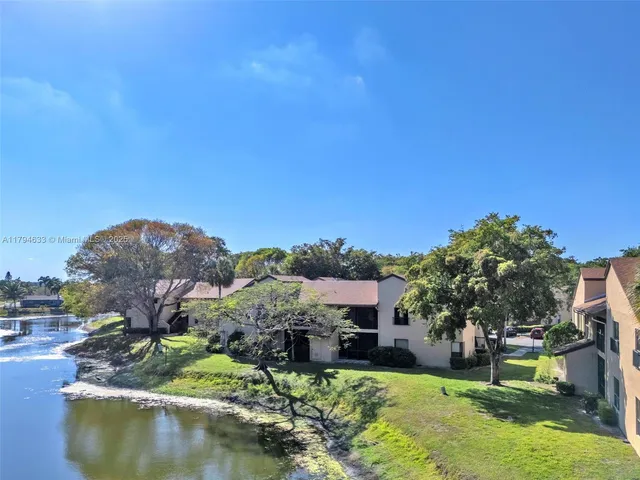 a view of a house with a yard and a garden