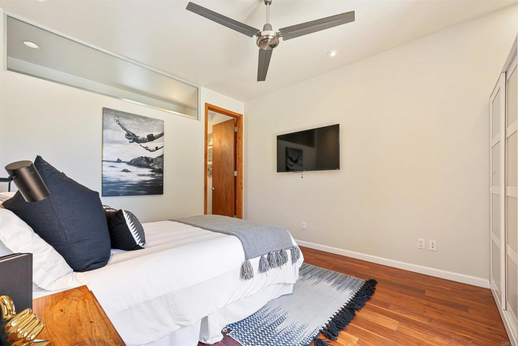 3312 James Drive Carlsbad, CA 92008 - Photo 20 of 41 a bedroom with a bed and wooden floor