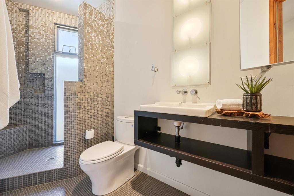 3312 James Drive Carlsbad, CA 92008 - Photo 21 of 41 a bathroom with a sink a toilet and shower