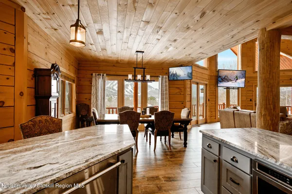 a living room with furniture a fireplace and a floor to ceiling window