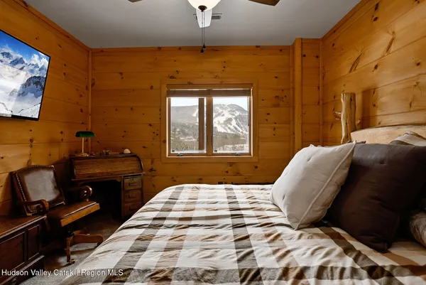 a bedroom with a bed and a chandelier
