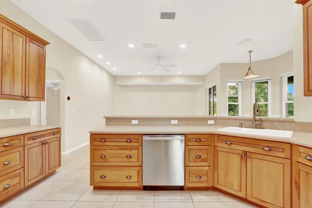 a view of a kitchen with refrigerator and a sink