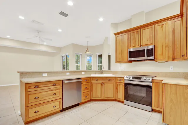 an empty room with a ceiling fan and window