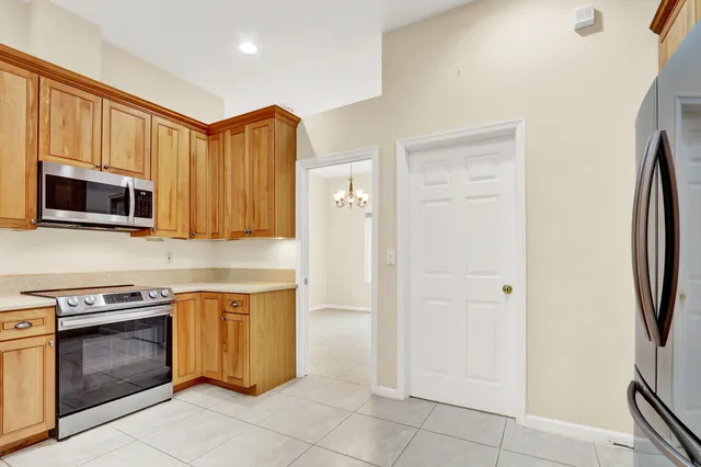 a utility room with stainless steel appliances washer and dryer