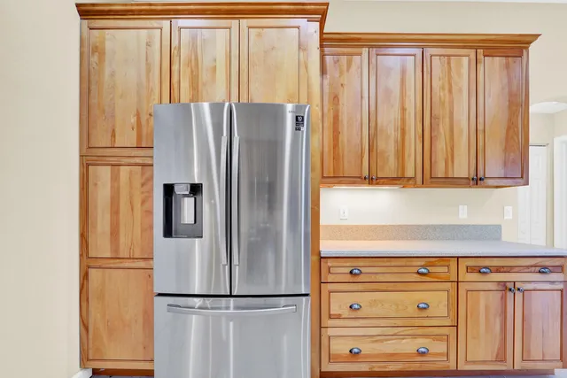 an empty room with a window and a ceiling fan
