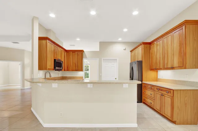 a bathroom with a sink a toilet and a large mirror