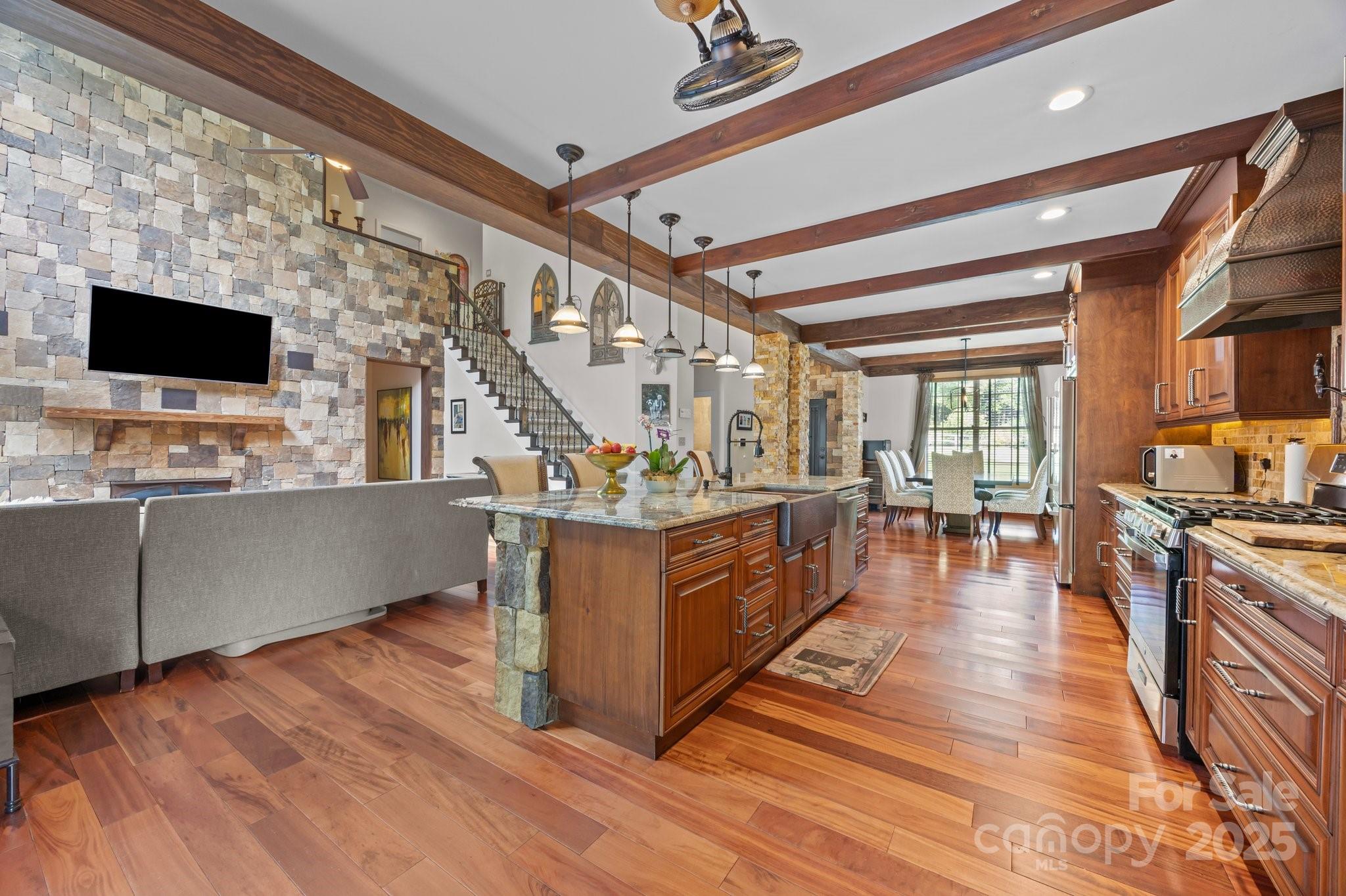 10919 Valley Spring Drive Charlotte, NC 28277 - Photo 13 of 47 a living room with stainless steel appliances kitchen island granite countertop a stove a sink and a wooden floors