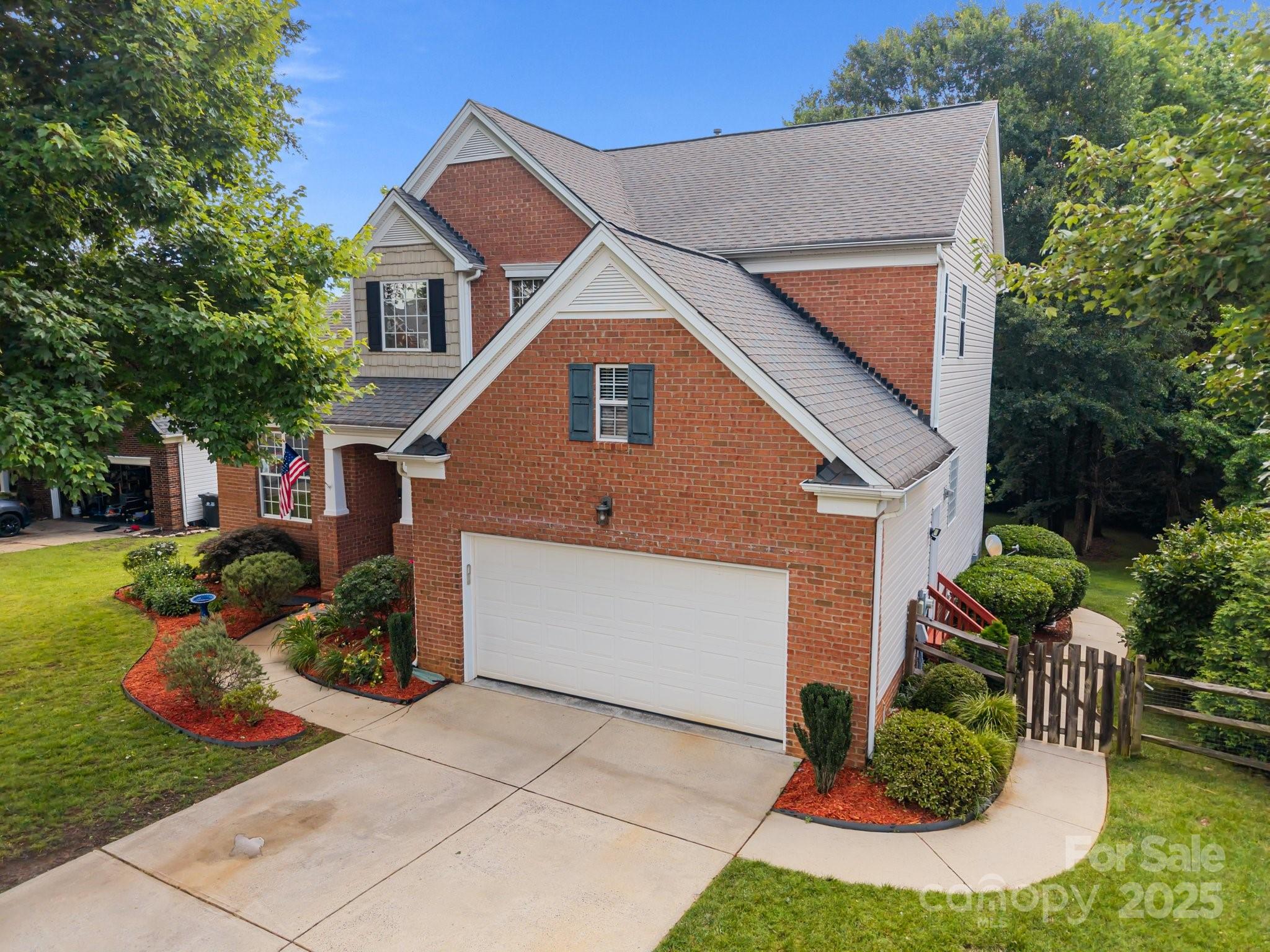 10919 Valley Spring Drive Charlotte, NC 28277 - Photo 2 of 47 a front view of a house with a yard and potted plants