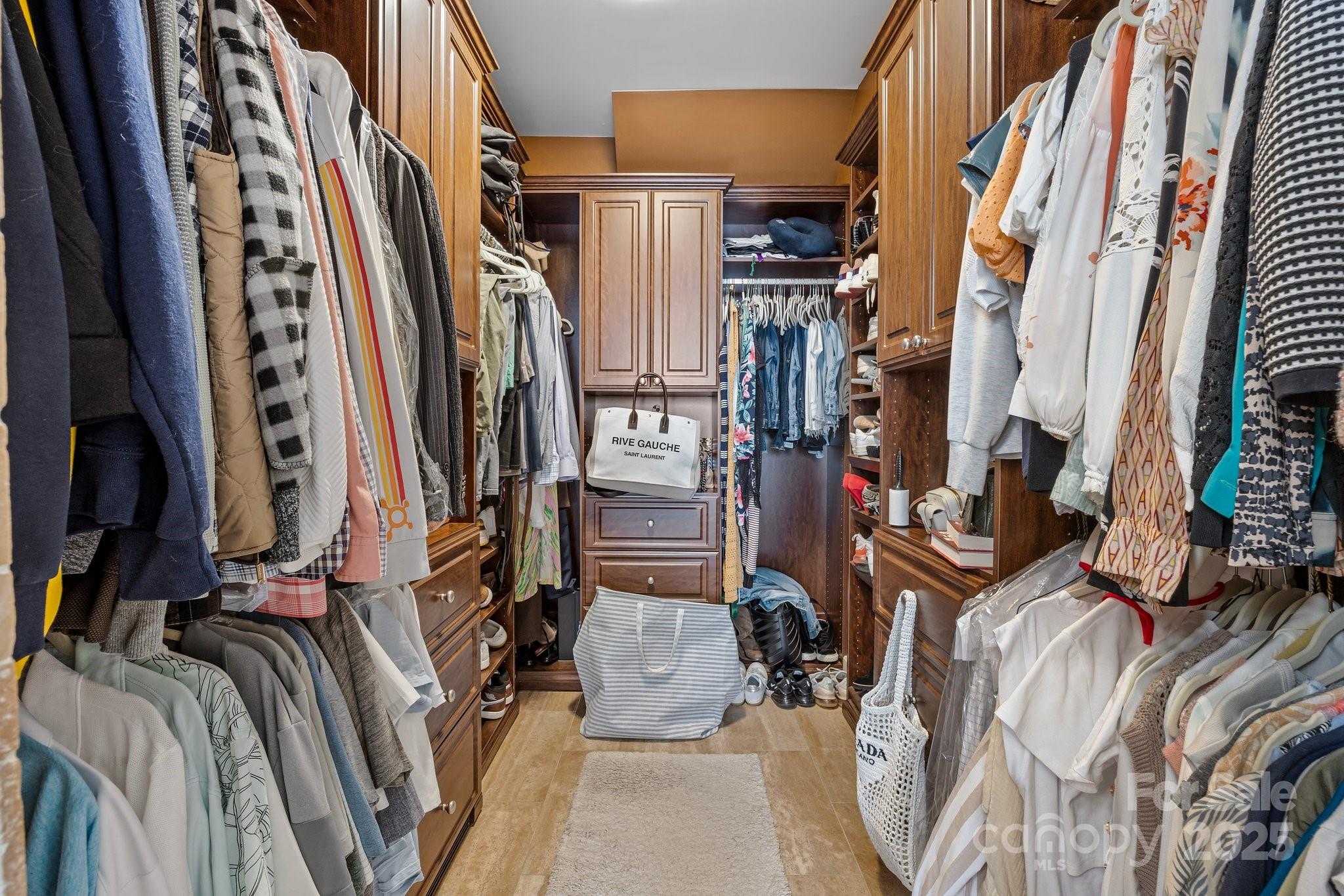 10919 Valley Spring Drive Charlotte, NC 28277 - Photo 24 of 47 a view of walk in closet with clothes