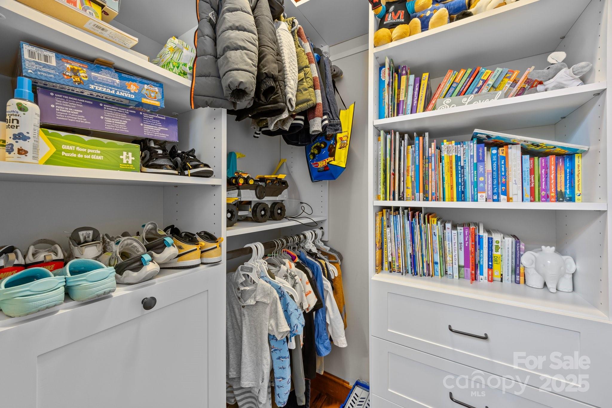 10919 Valley Spring Drive Charlotte, NC 28277 - Photo 30 of 47 a view of walk in closet with clothes and shoes