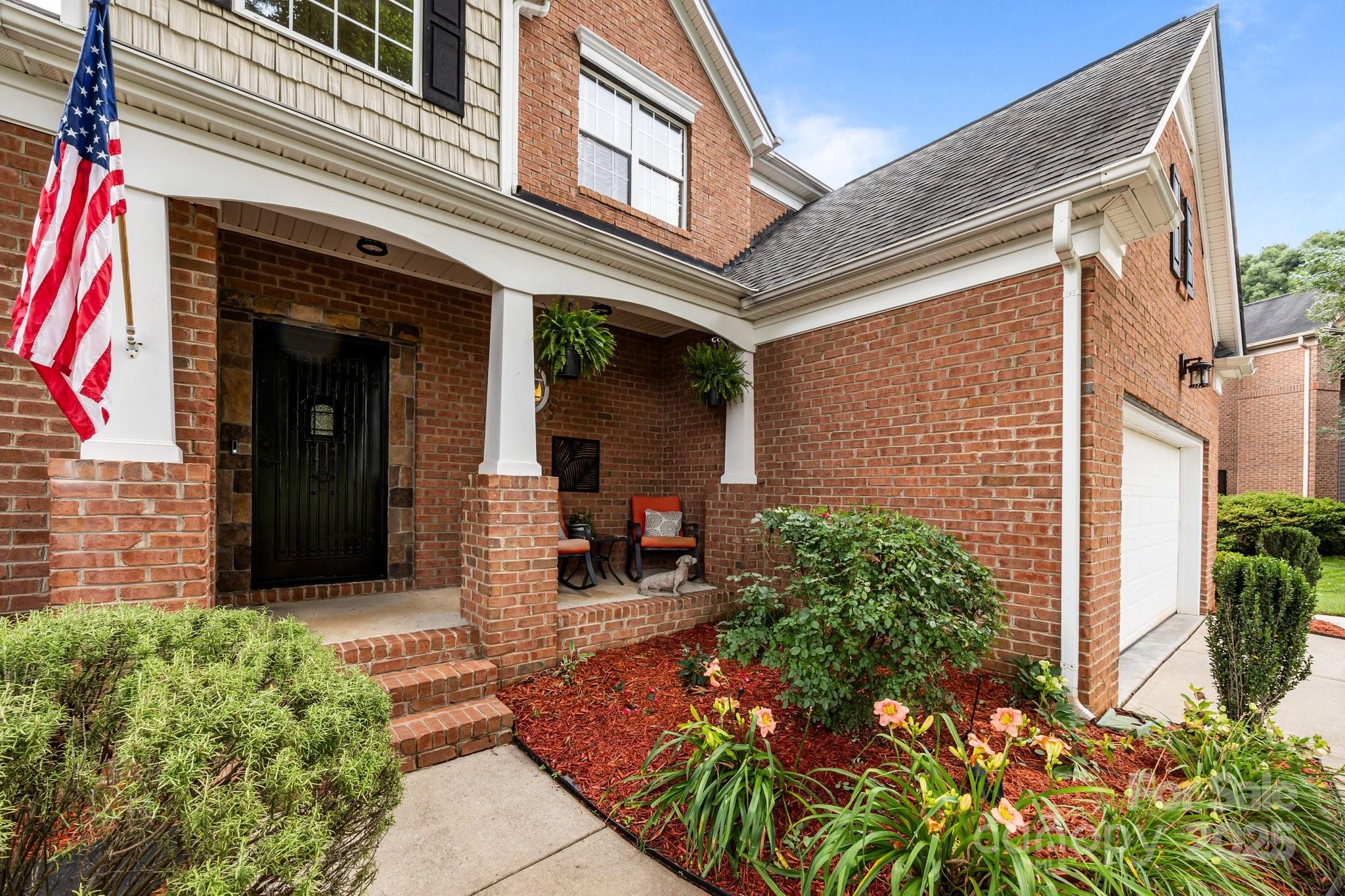 10919 Valley Spring Drive Charlotte, NC 28277 - Photo 4 of 47 a front view of a house with garden