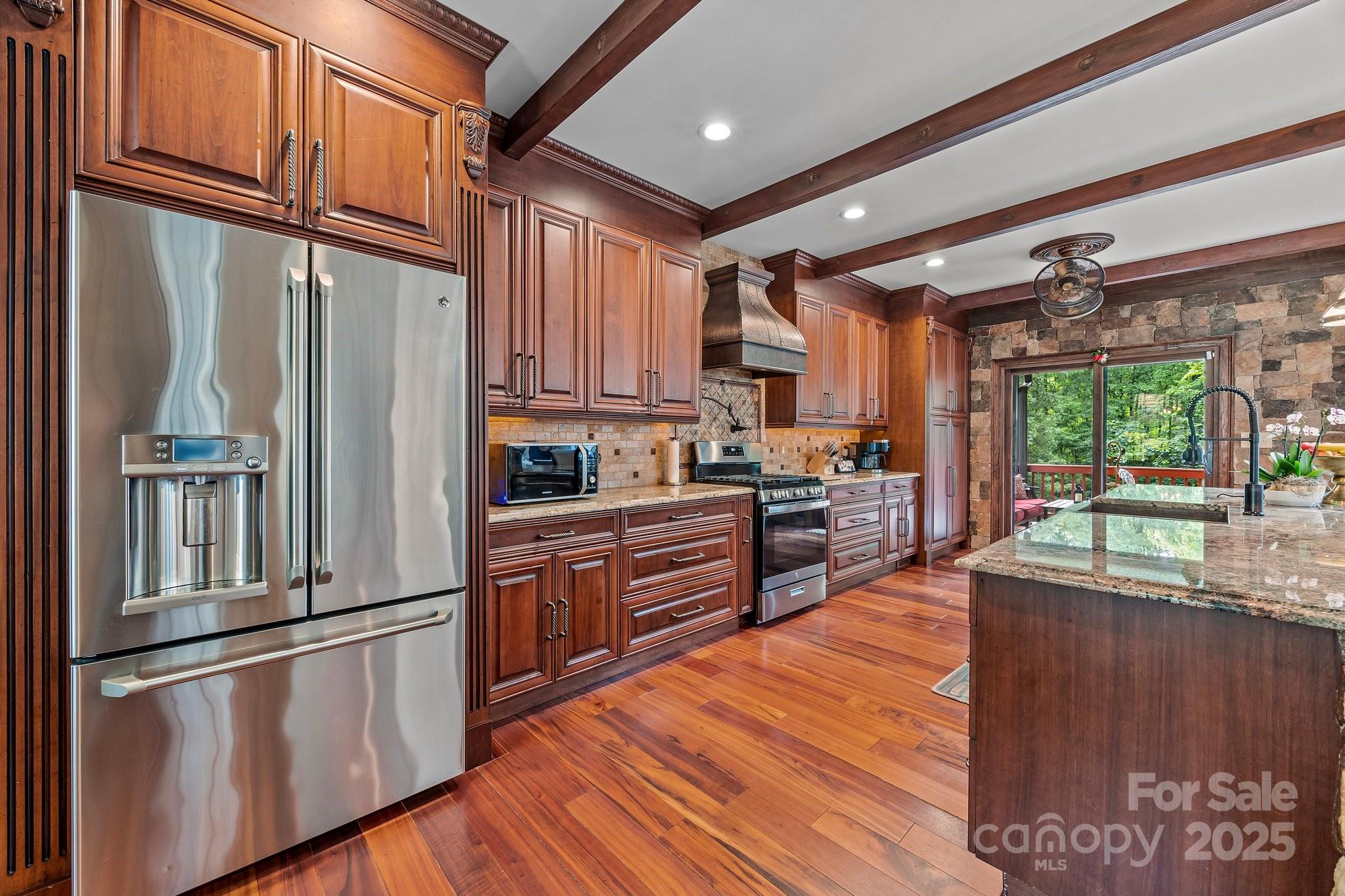 10919 Valley Spring Drive Charlotte, NC 28277 - Photo 7 of 47 a kitchen with stainless steel appliances granite countertop a refrigerator a sink dishwasher a stove and white countertops with wooden floor
