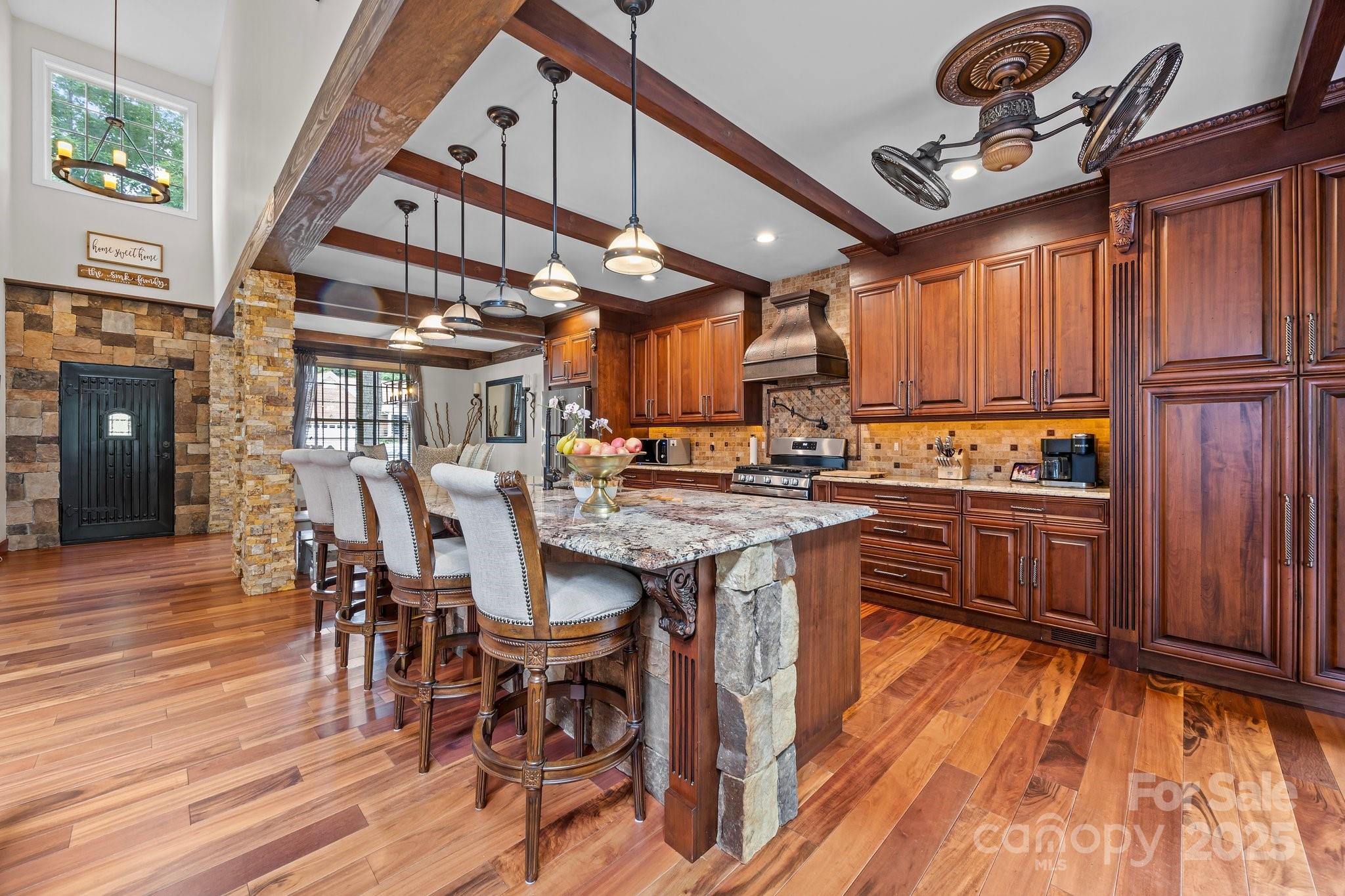 10919 Valley Spring Drive Charlotte, NC 28277 - Photo 8 of 47 a kitchen with stainless steel appliances granite countertop a stove a refrigerator a dining table and chairs with wooden floor