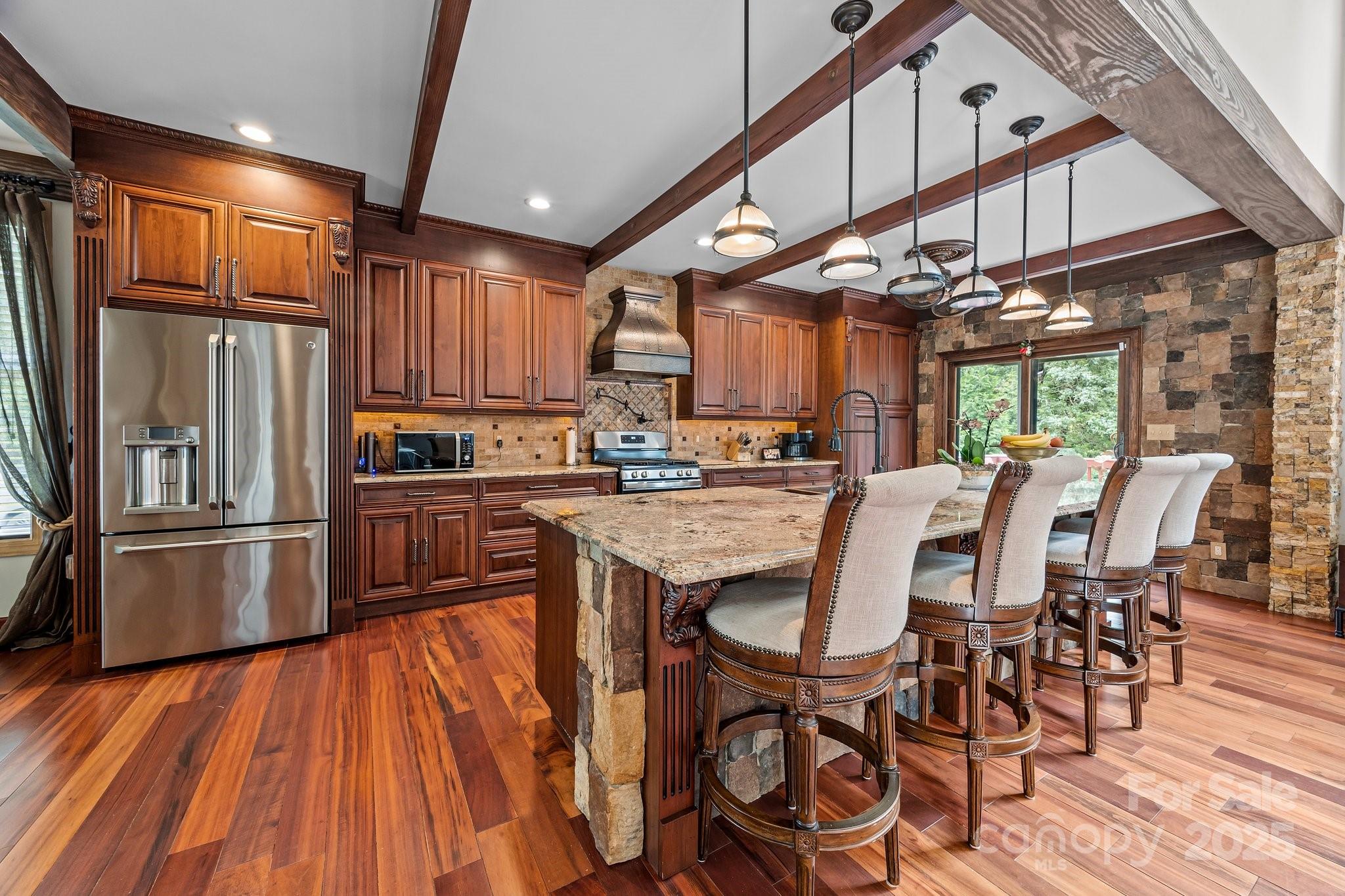 10919 Valley Spring Drive Charlotte, NC 28277 - Photo 9 of 47 a kitchen with stainless steel appliances granite countertop a refrigerator a sink dishwasher a stove and a dining table with wooden floor