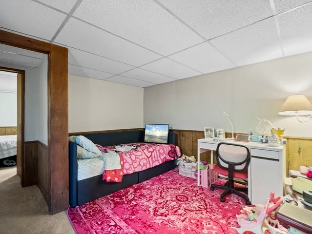 a bathroom with a toilet a sink and a mirror