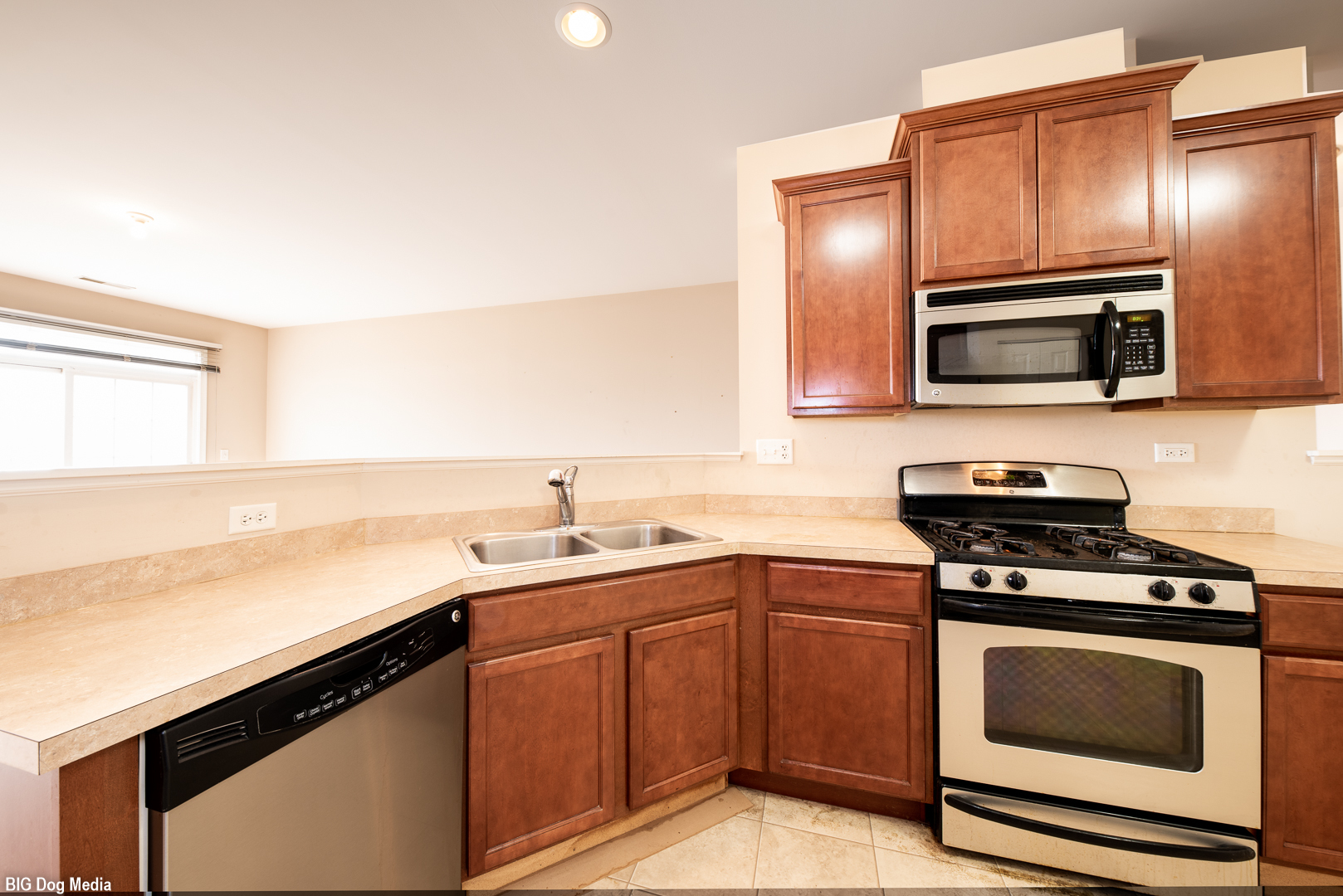 10225 Mulberry Lane, Unit J Bridgeview, IL 60455 - Photo 12 of 24 a kitchen with stainless steel appliances a stove microwave and sink