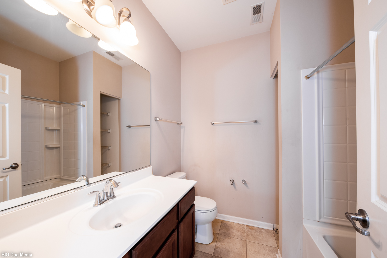 10225 Mulberry Lane, Unit J Bridgeview, IL 60455 - Photo 15 of 24 a bathroom with a sink a toilet and a large mirror