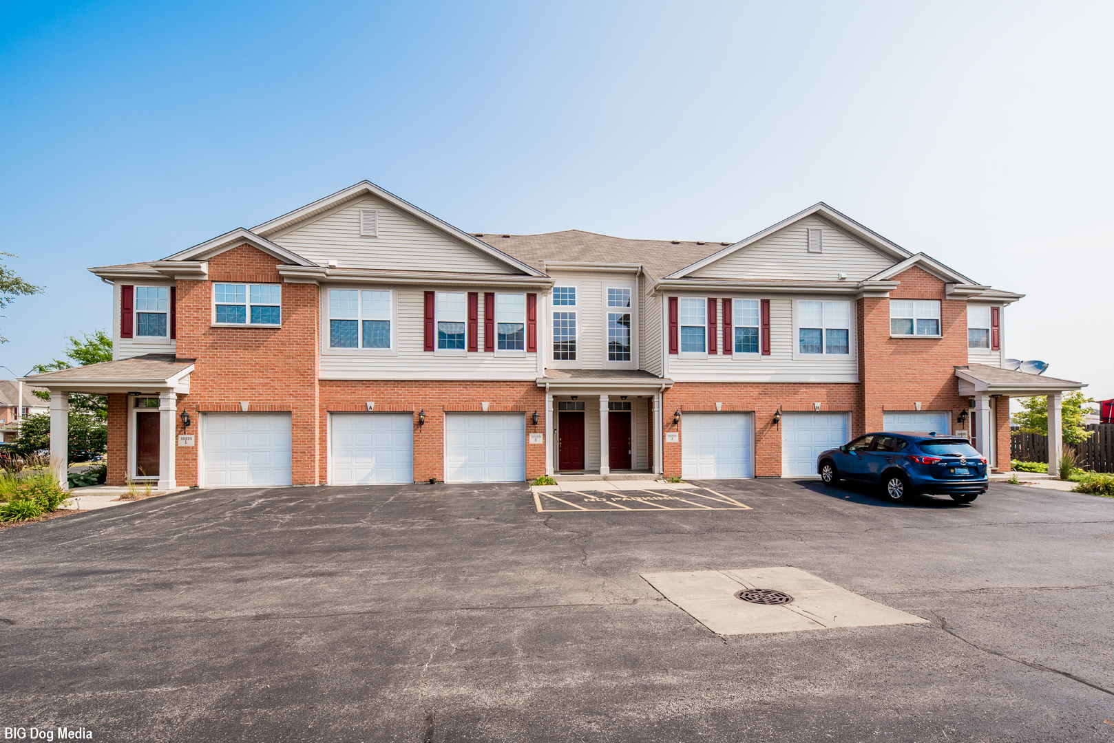 10225 Mulberry Lane, Unit J Bridgeview, IL 60455 - Photo 24 of 24 a car parked in front of a white house