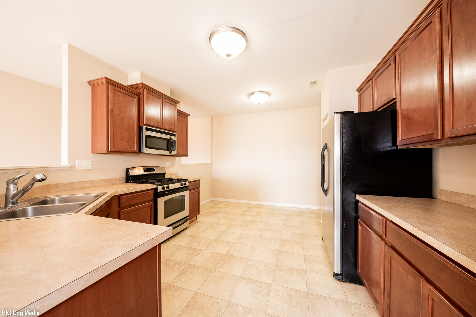 10225 Mulberry Lane, Unit J Bridgeview, IL 60455 - Photo 8 of 24 a kitchen with stainless steel appliances granite countertop a sink stove and refrigerator