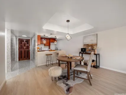 a view of a dining room with furniture and wooden floor
