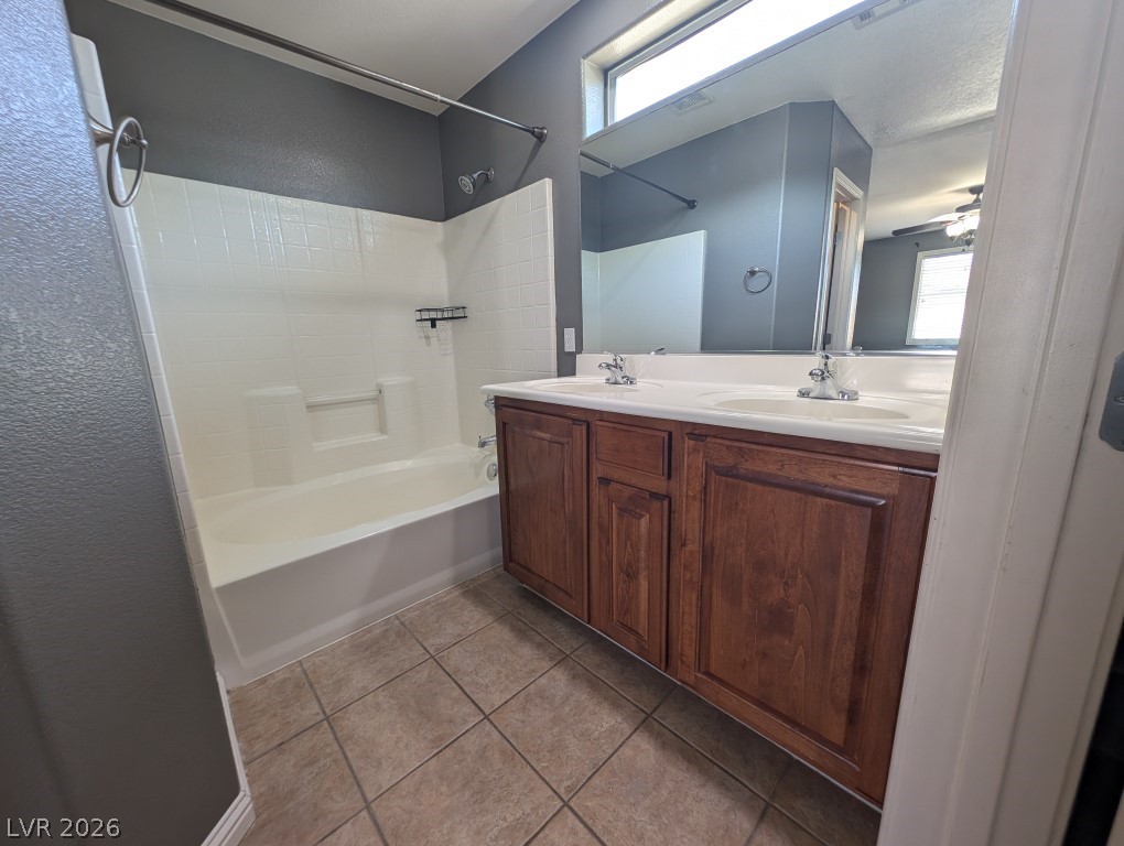 9121 Spoonbill Ridge Place Las Vegas, NV 89143 - Photo 15 of 26 Double vanity and tiled shower/tub combo make this bathroom both practical and comfortable.
