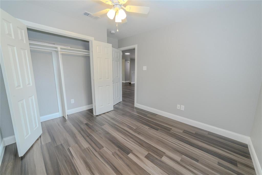 809 Wilcox Street McKinney, TX 75069 - Photo 23 of 26 Unfurnished bedroom featuring a ceiling fan, dark wood-style floors, and a closet