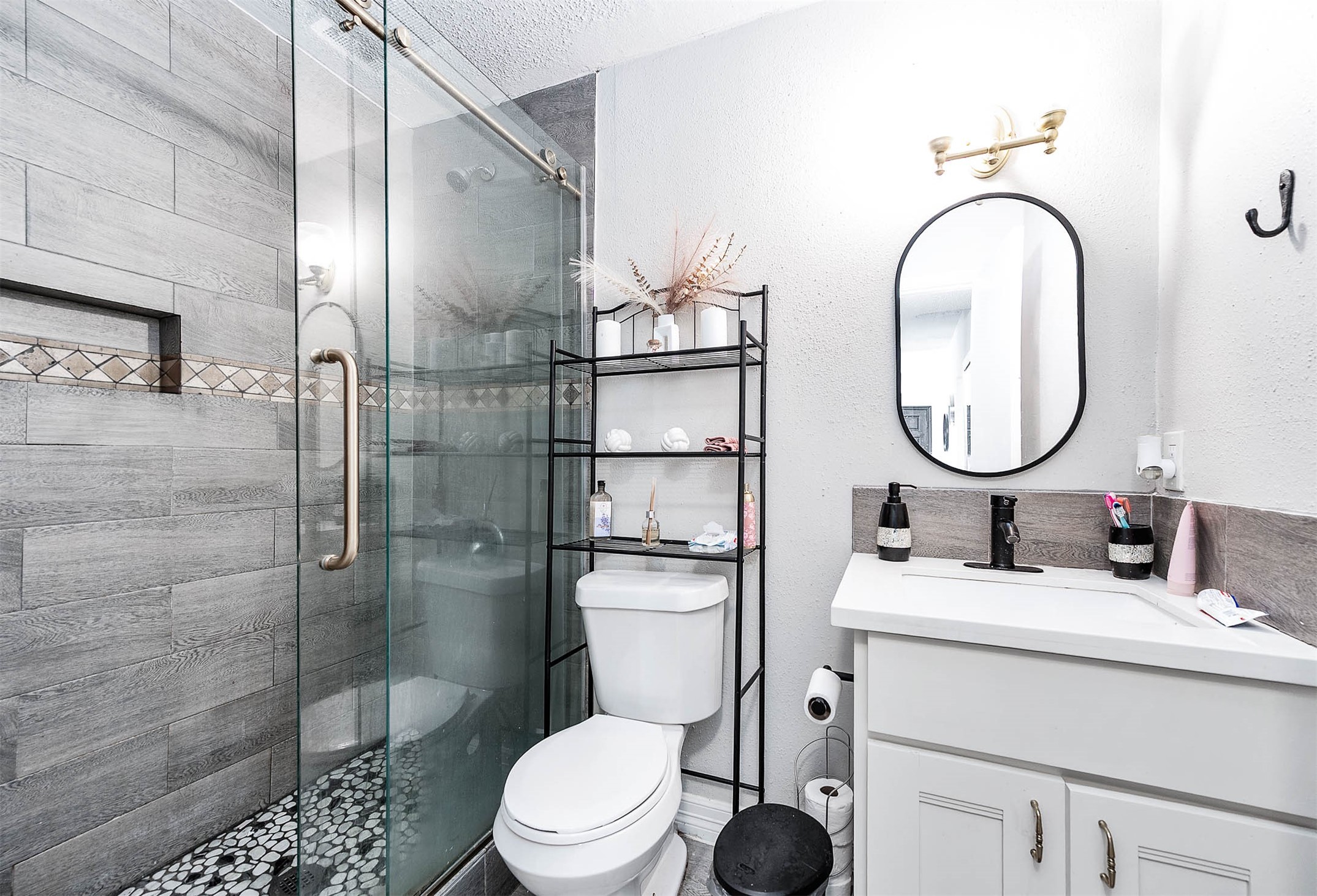 18446 North Willow Bluff Road Katy, TX 77449 - Photo 17 of 31 a bathroom with a sink a toilet and a mirror