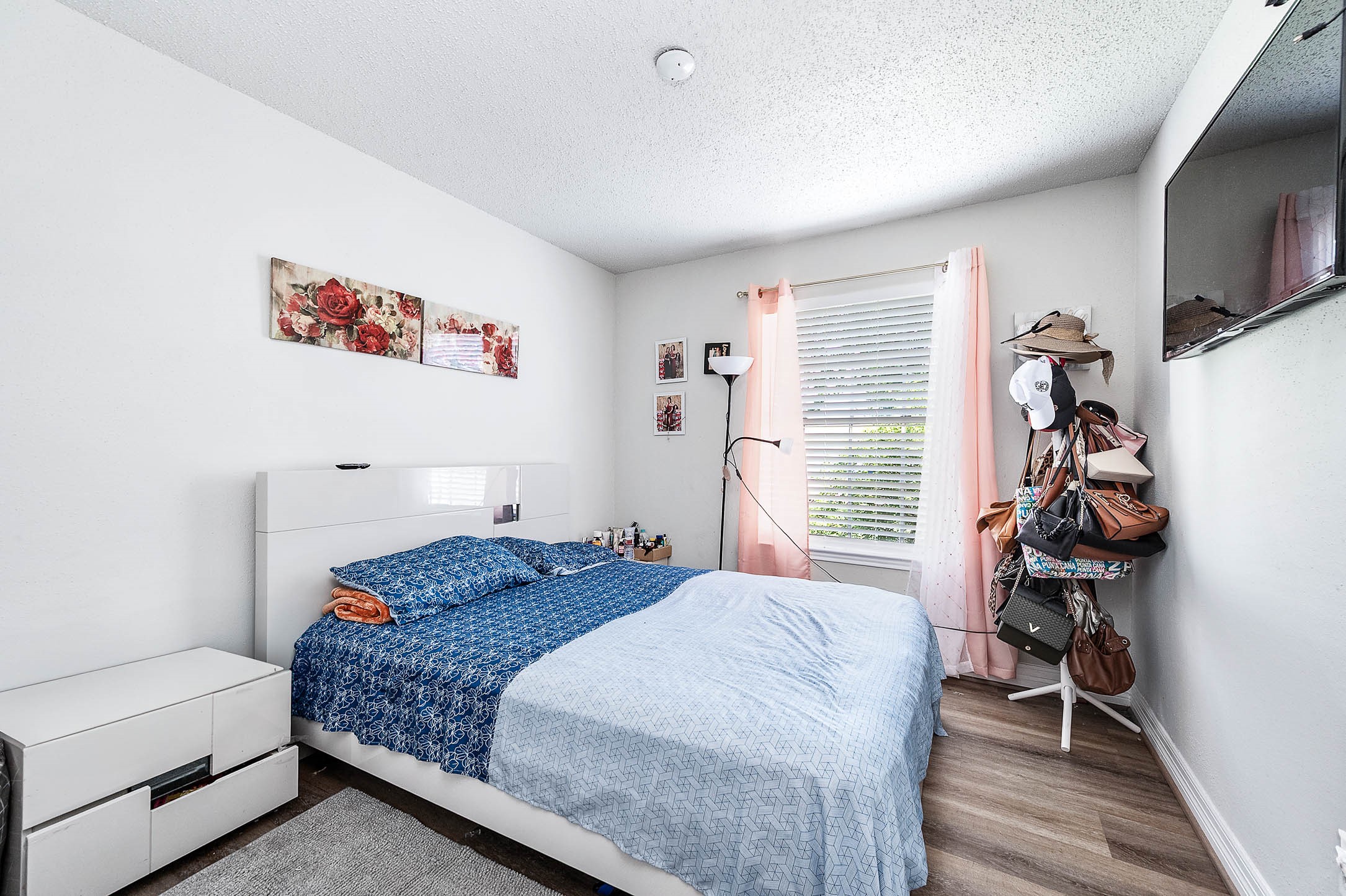 18446 North Willow Bluff Road Katy, TX 77449 - Photo 18 of 31 a bedroom with a bed and a flat tv screen on the dresser