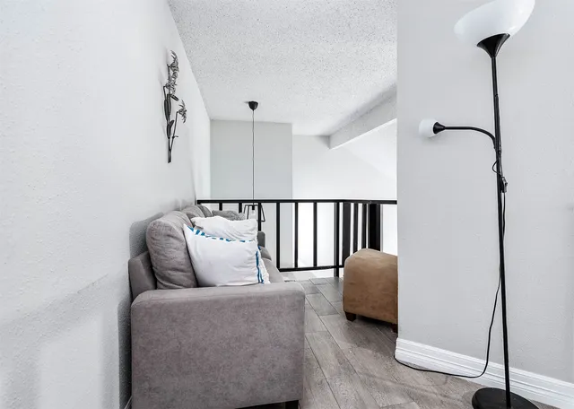 a living room with furniture and a ceiling fan