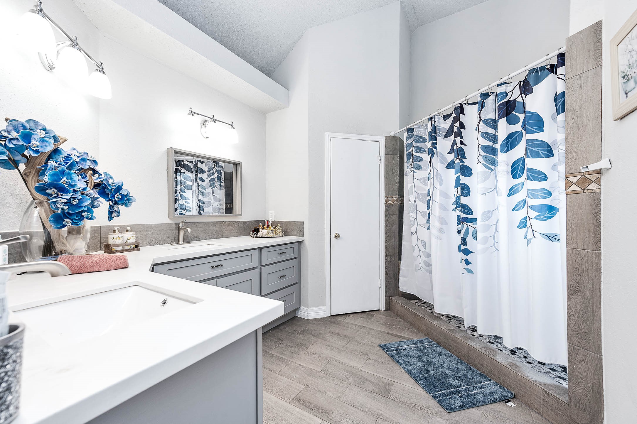 18446 North Willow Bluff Road Katy, TX 77449 - Photo 26 of 31 a spacious bathroom with a sink mirror and shower