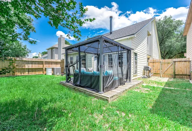 a view of a house with a yard and a porch