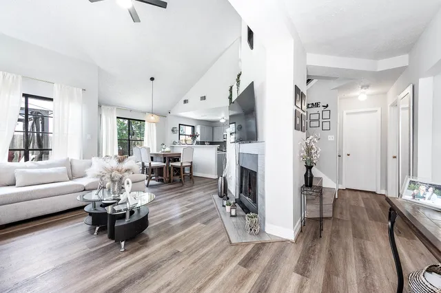a living room with fireplace furniture and a wooden floor