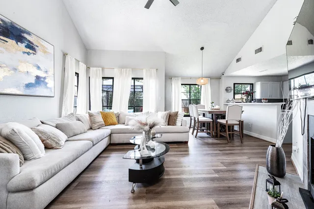 a living room with furniture or couch and a dining table