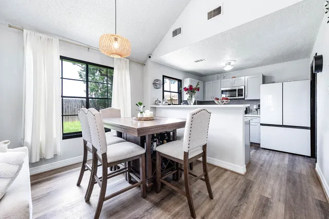 a view of a dining room with furniture window and wooden floor