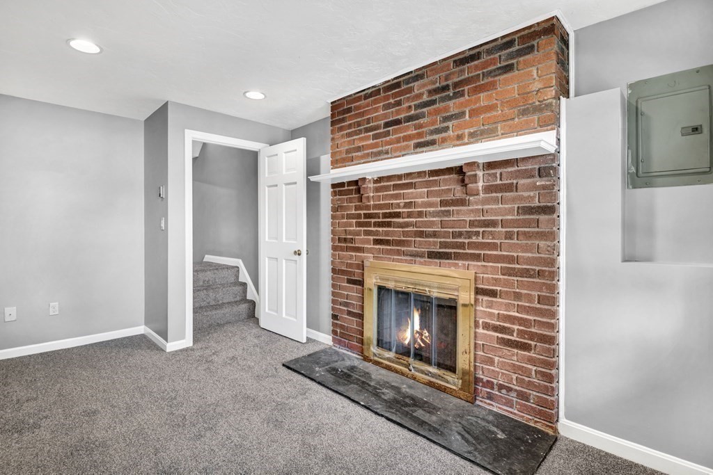 26 Indian Road Waltham, MA 02451 - Photo 23 of 32 a view of a livingroom with a fireplace and window