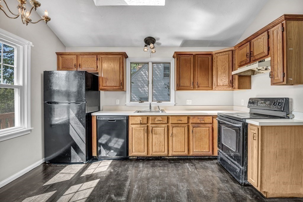 26 Indian Road Waltham, MA 02451 - Photo 7 of 32 a kitchen with stainless steel appliances granite countertop a refrigerator a stove a sink and a microwave