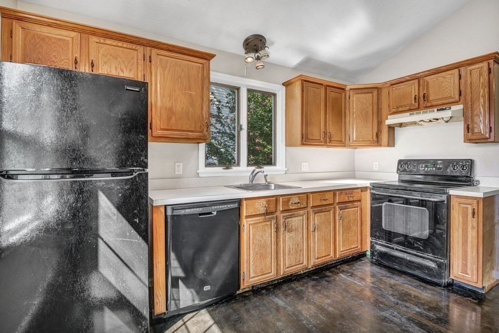 26 Indian Road Waltham, MA 02451 - Photo 8 of 32 a kitchen with granite countertop a sink stainless steel appliances and cabinets