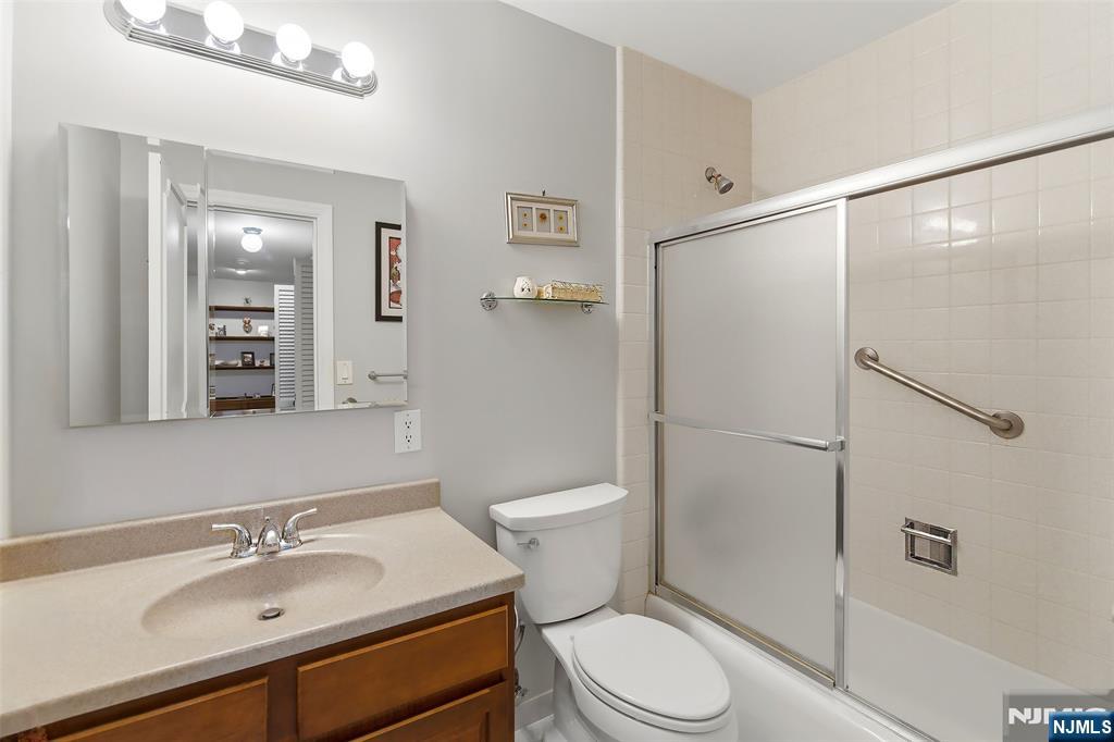 280 Prospect Avenue, Unit 8G Hackensack, NJ 07601 - Photo 14 of 23 a bathroom with a sink a toilet and shower