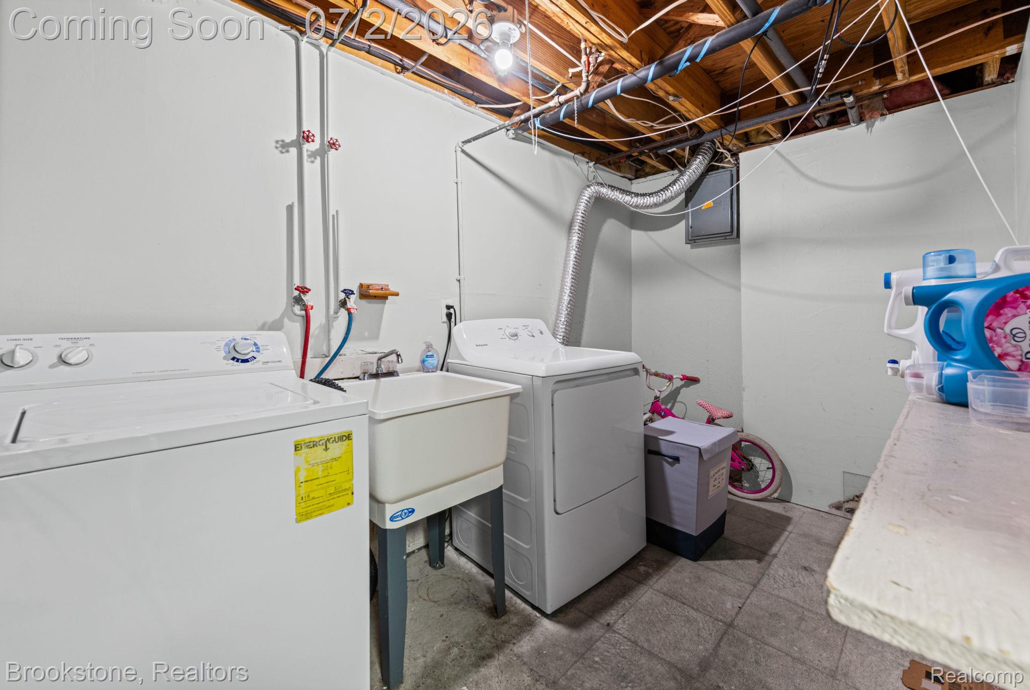 1925 Nicholas Court Warren, MI 48092 - Photo 22 of 26 Dedicated utility area featuring a laundry sink with hot and cold water hookups, exposed ceiling joists, and a concrete floor