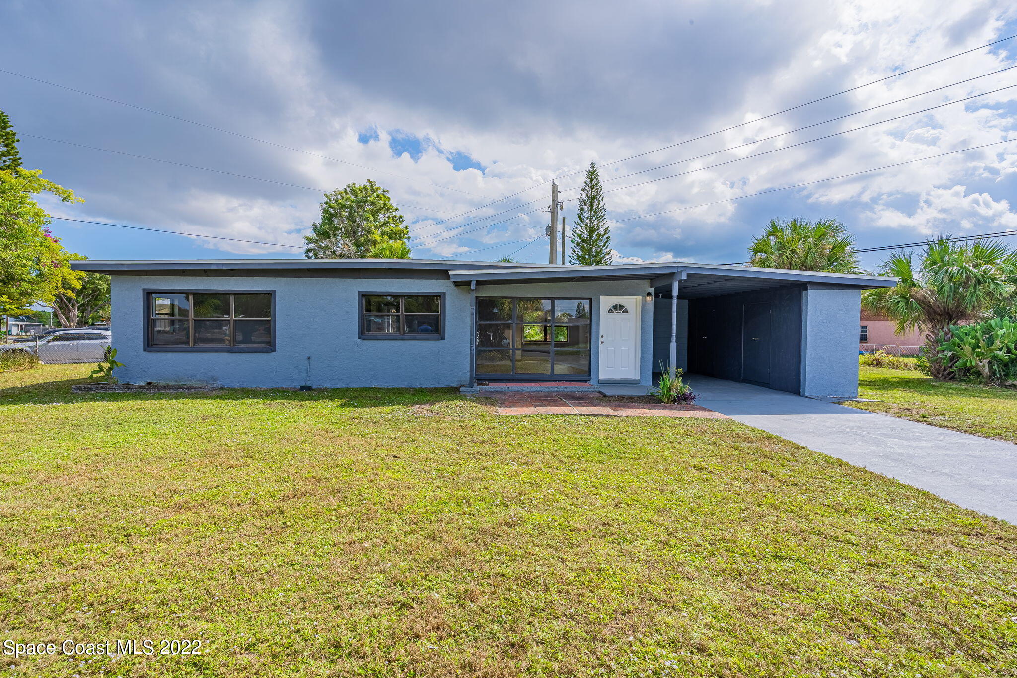 302 Prospect Avenue Cocoa, FL 32922 - Photo 1 of 28 a front view of a house with a yard and potted plants