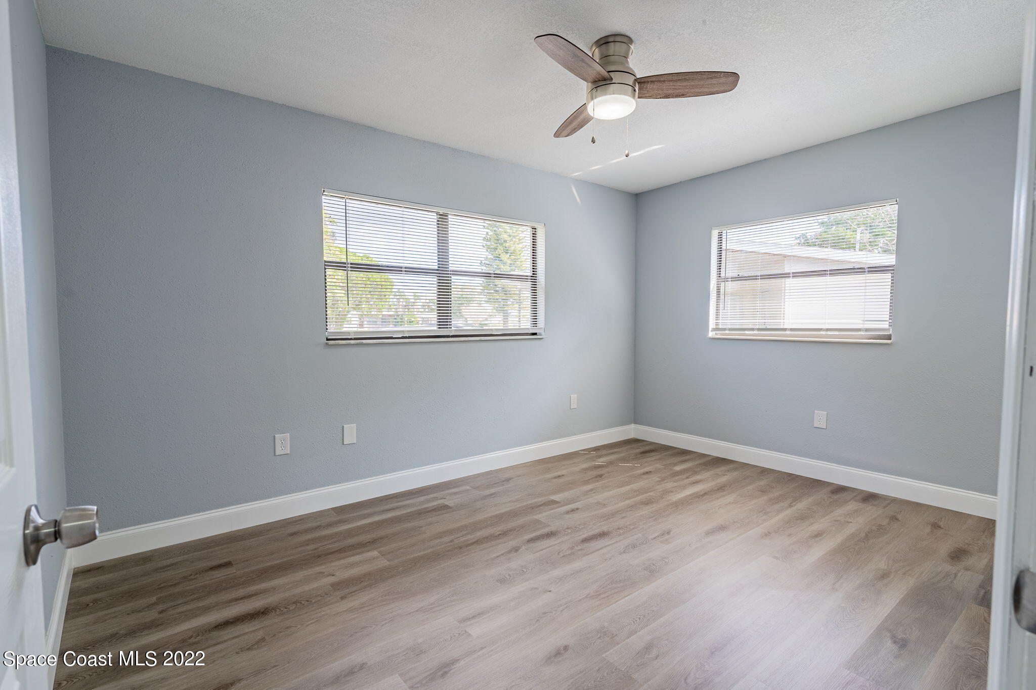 302 Prospect Avenue Cocoa, FL 32922 - Photo 11 of 28 a view of an empty room with a window and a chandelier fan