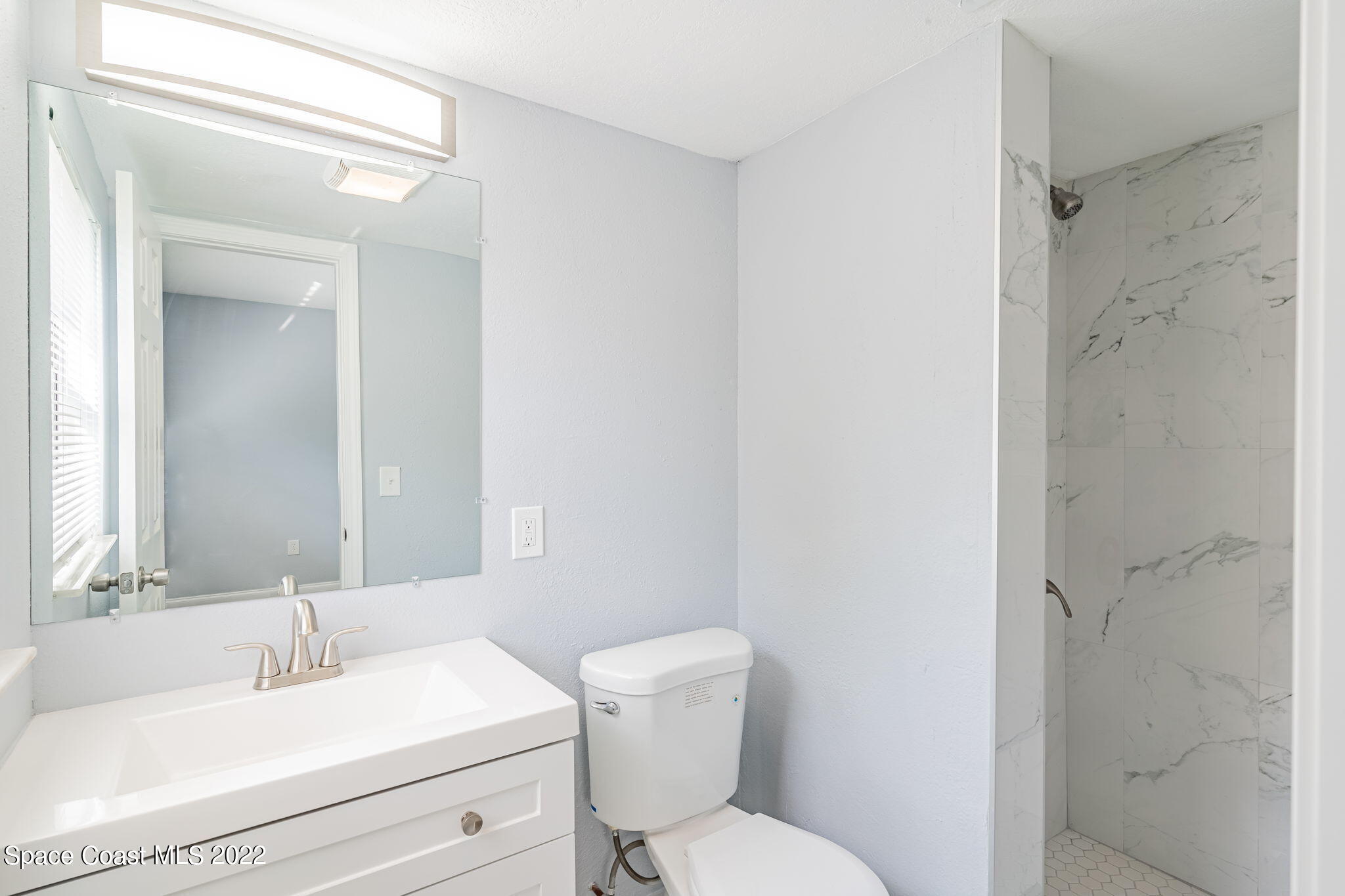 302 Prospect Avenue Cocoa, FL 32922 - Photo 14 of 28 a bathroom with a toilet a sink and a mirror