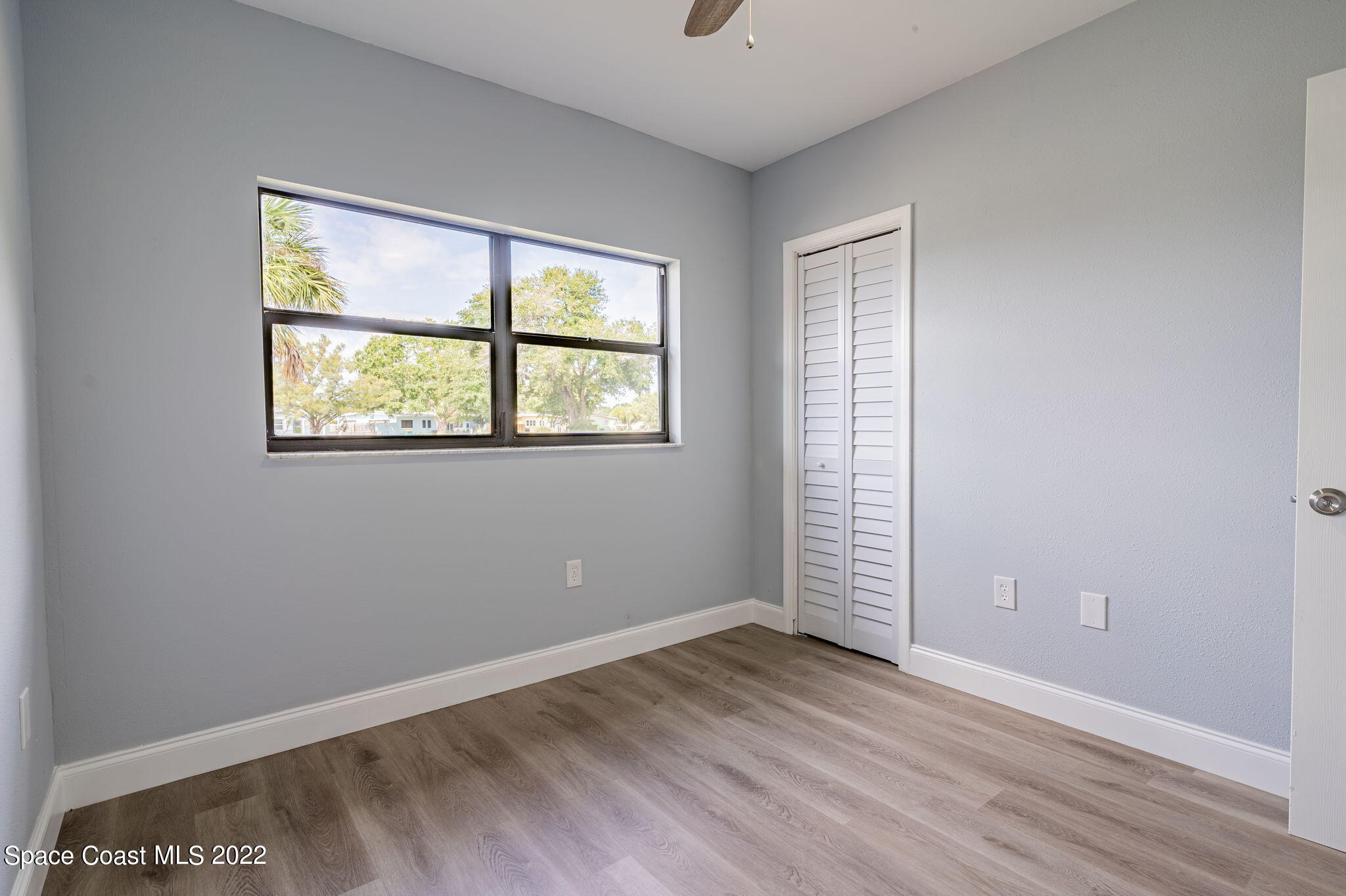 302 Prospect Avenue Cocoa, FL 32922 - Photo 17 of 28 an empty room with wooden floor and windows