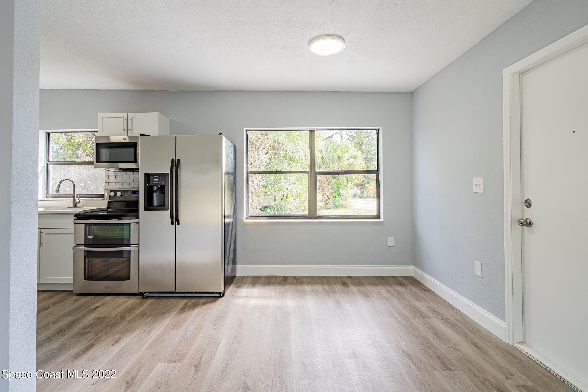 302 Prospect Avenue Cocoa, FL 32922 - Photo 7 of 28 a kitchen with a refrigerator and a stove top oven