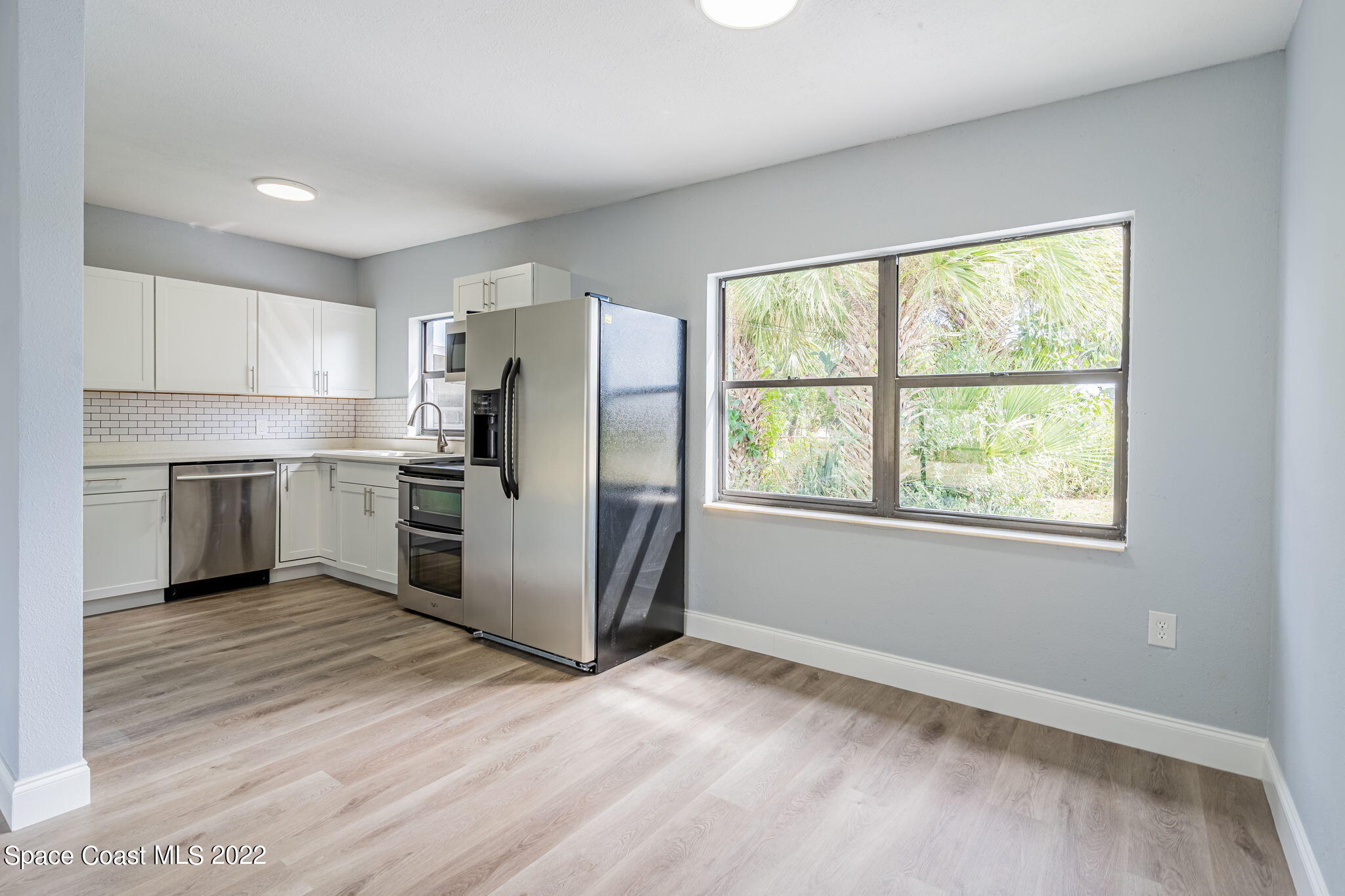 302 Prospect Avenue Cocoa, FL 32922 - Photo 8 of 28 a kitchen with a refrigerator a oven a stove top oven and white cabinets