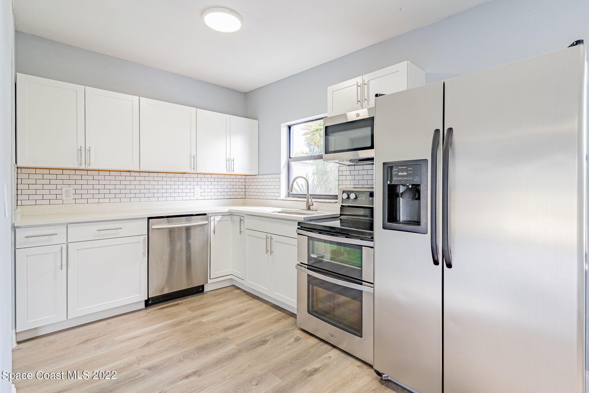 302 Prospect Avenue Cocoa, FL 32922 - Photo 9 of 28 a kitchen with cabinets stainless steel appliances and sink