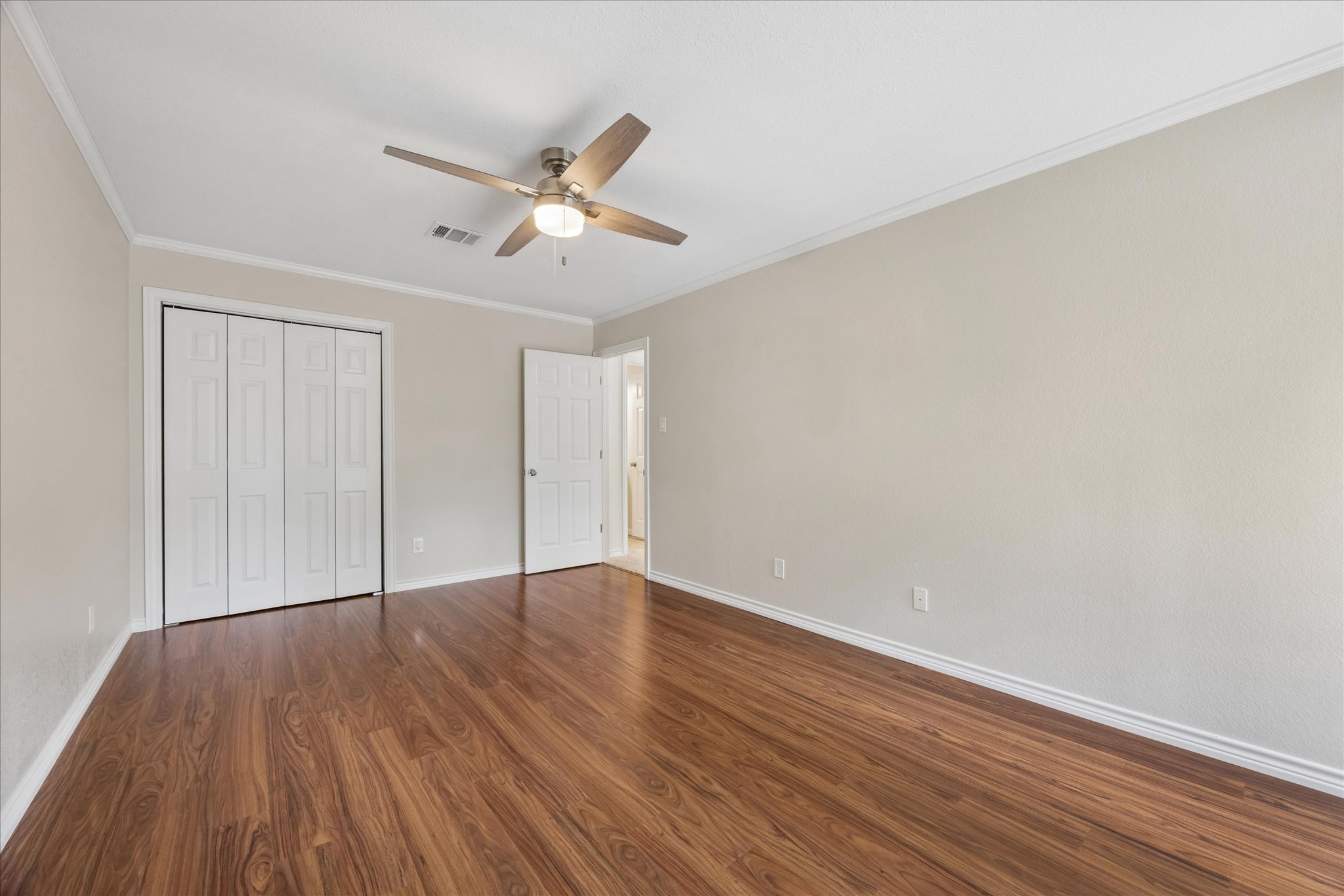 1306 Shady Grove Path Cedar Park, TX 78613 - Photo 30 of 40 an empty room with wooden floor fan and windows